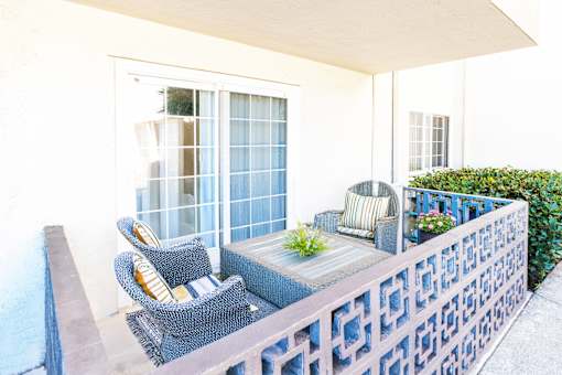 A patio with a table and chairs.
