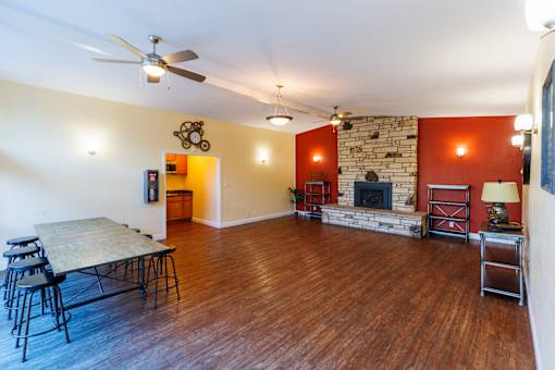 A living room with a fireplace and a dining table.