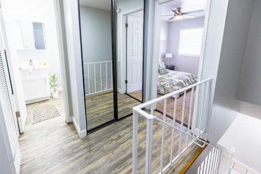 A bedroom with a bed and a ceiling fan.