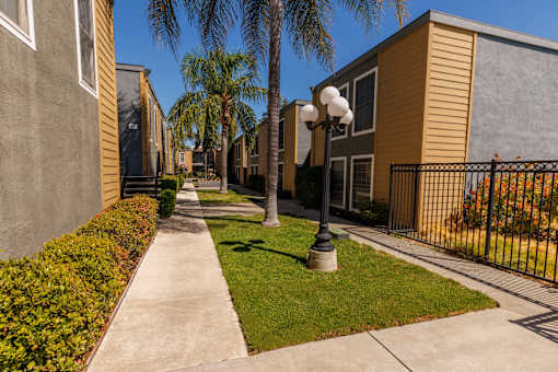 A row of houses with a sidewalk and a lamp post.