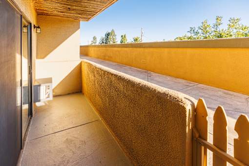 A sunny day at a modern house with a balcony.