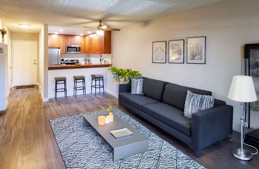 A living room with a grey couch and a coffee table in front of it.