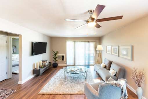 A living room with a ceiling fan and a couch.