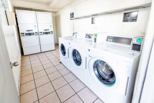 A row of washing machines in a laundromat.