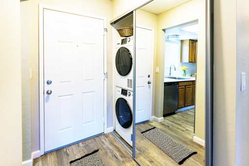 A white door is open to a kitchen.