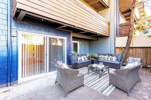A patio with a table and chairs.