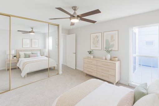 A bedroom with a bed, dresser, and mirror.