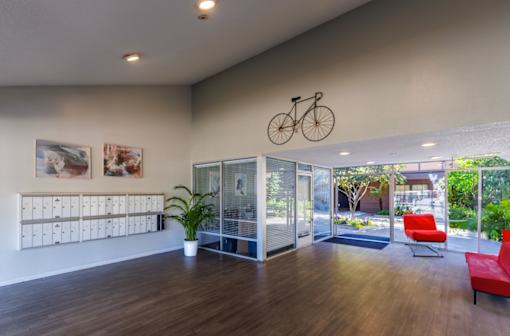 the preserve at cardinal woods lobby with red chairs and a bicycle hanging from the ceiling