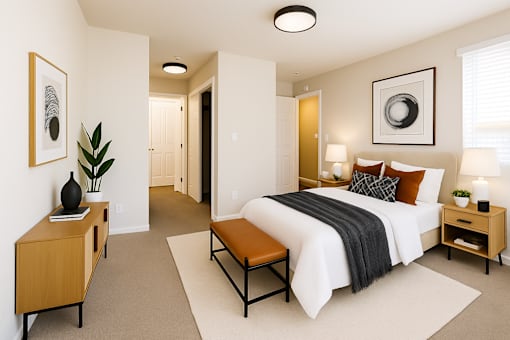 A bedroom with a large bed, a nightstand, and a bench.