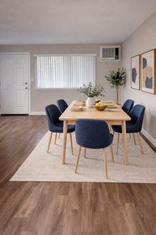 A dining room with a table set for six.