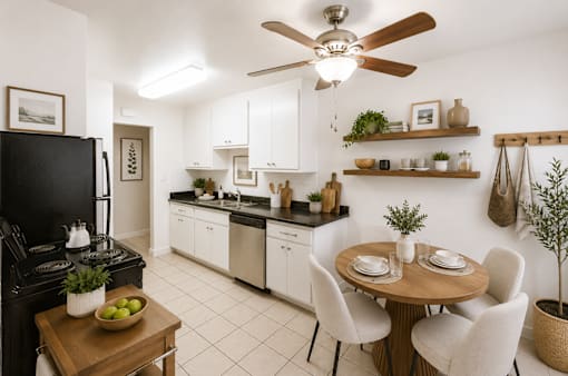 A kitchen with a black stove top oven and white cabinets.