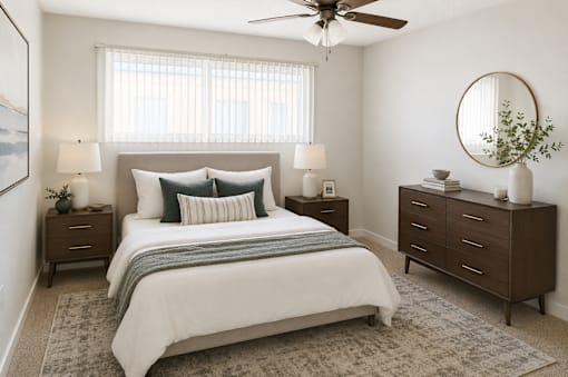 A bedroom with a large bed, two nightstands, and a ceiling fan.