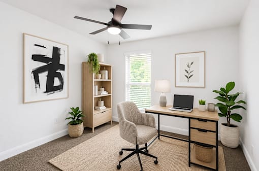 A room with a desk, chair, and a ceiling fan.