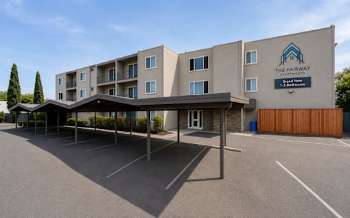 The Fairway Apartment building has a parking lot in front.