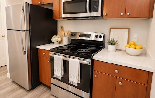 A black stove top oven with a white towel on it.