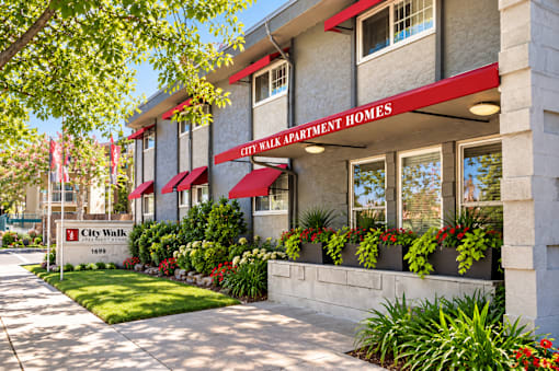 A building with the sign "City Walk Apartment Homes" in front of it.