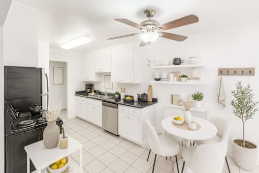 A modern kitchen with a dining table and chairs.