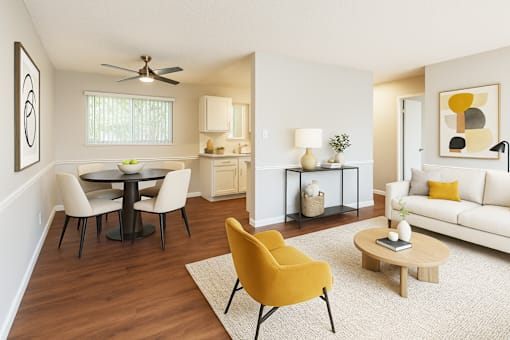 A living room with a yellow chair and a white couch.