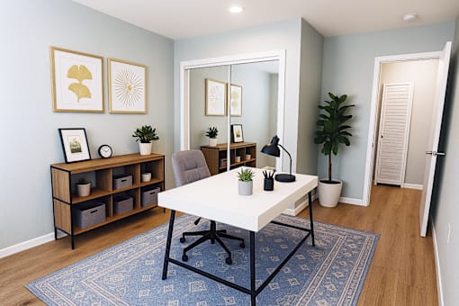 A room with a white table and a blue rug.
