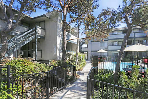 A modern building with a pool in the courtyard.