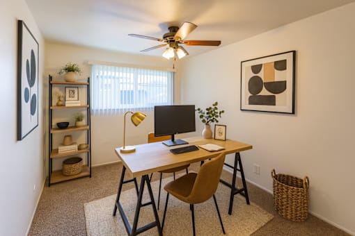 A room with a desk and a chair.