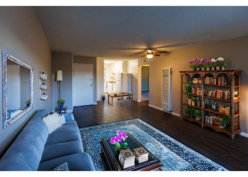 a living room with a blue couch and a rug