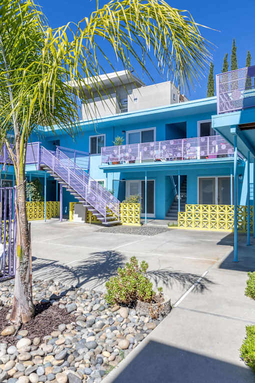 A blue house with a purple staircase.
