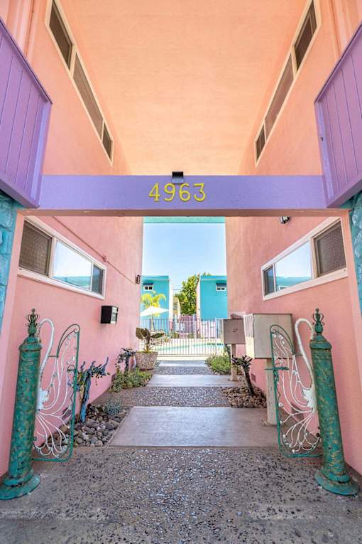 A pink building with a number 4963 on the top.