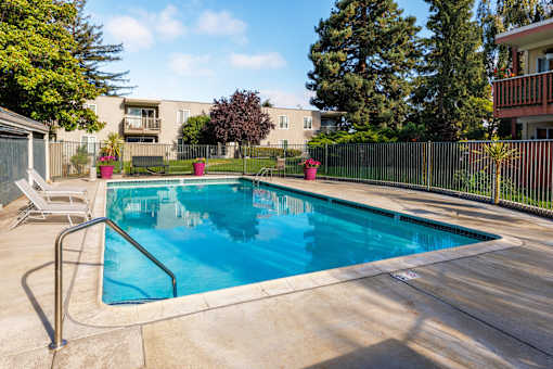 A small pool with a metal fence around it.