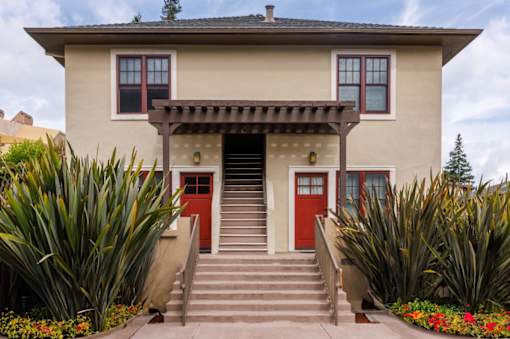 a house with red doors and a staircase