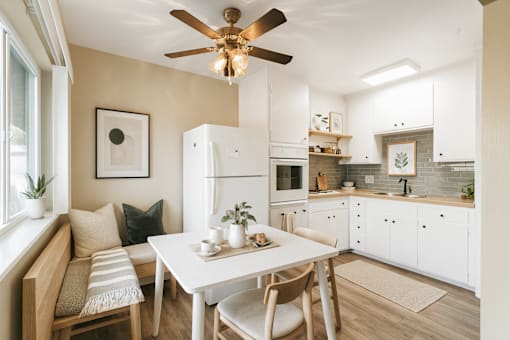 A modern kitchen with a dining table and chairs.