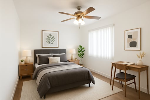 A bedroom with a bed, desk, and chair.