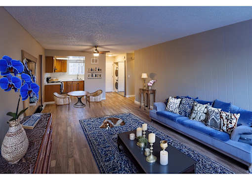 a living room with blue couches and a coffee table