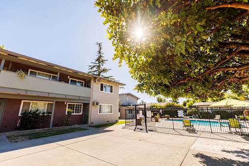 A sunny day at the apartment complex with a pool in the background.