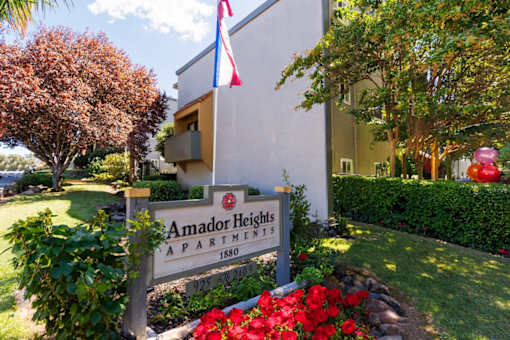A sign for Amador Heights Apartments is in front of a building.
