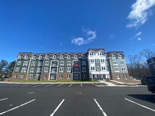 A large building with a parking lot in front of it.