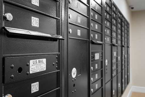 A row of black mailboxes with numbers 212, 214, and 216 visible.