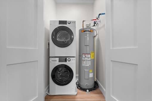 A washing machine and a water heater in a small room.