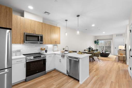 A modern kitchen with wooden cabinets and stainless steel appliances.