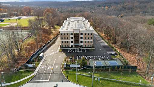 A large building with a parking lot in front of it.