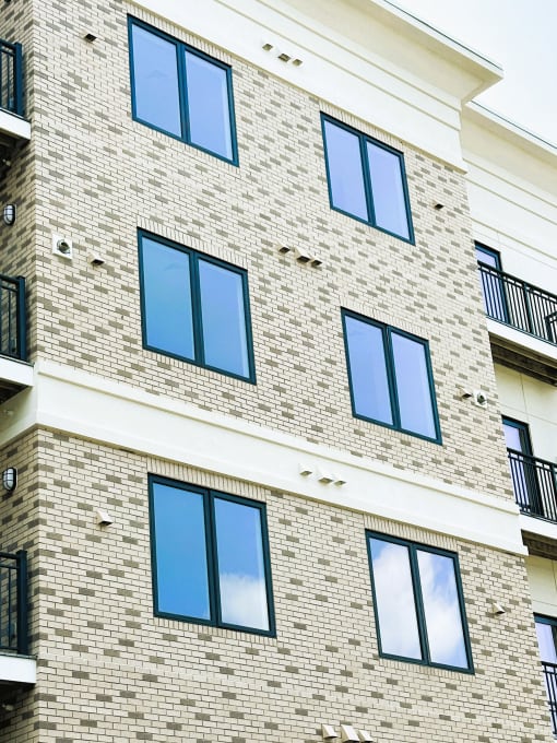 an exterior view of a brick building with large windows
