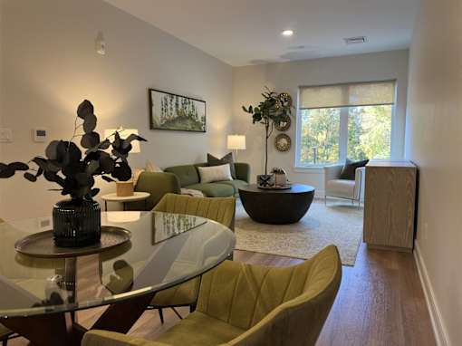 a living room with a table and chairs and a couch