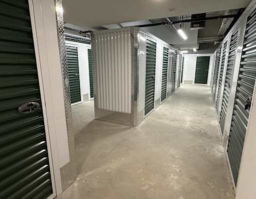 a view of a hallway in a data center with metal partitions