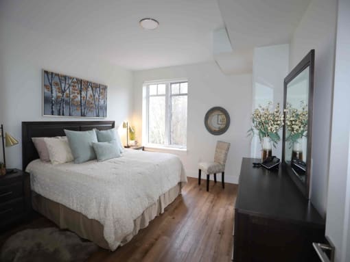 a bedroom with a bed and a dresser and a window