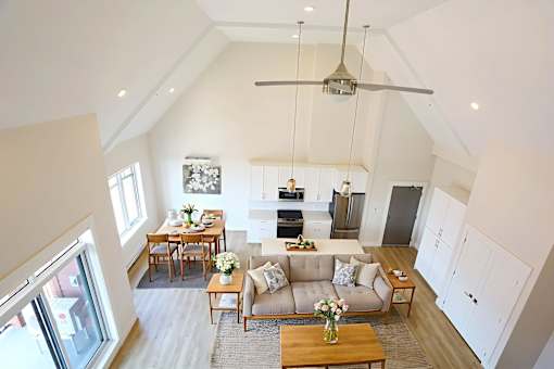 A living room with a couch, chairs, and a coffee table.
