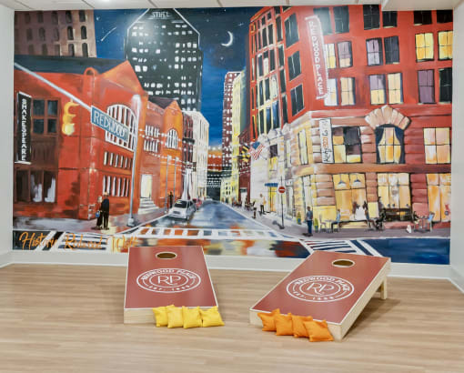 two boxes of popcorn in front of a painting of a city street