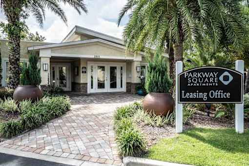 The image shows the entrance to the Parkway Square Apartments leasing office.