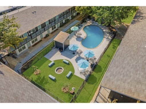 an overhead view of an apartment building and an outdoor pool