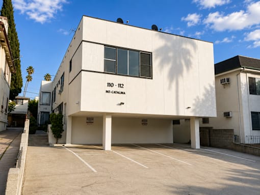 A white building with the number 110-112 on it.