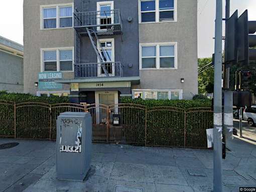 an apartment building with a parking meter in front of it